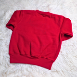 Red sweatshirt on a white fluffy surface
