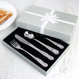Set of cutlery with 'Christopher' engraving in a gift box on a white surface.
