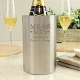 Personalized wine cooler for a 25th silver wedding anniversary with champagne and glasses on a table.