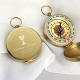 Gold compass with engraved text on a white background