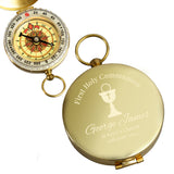 Gold compass with engraved text on a white background