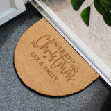 Doormat with 'Merry Christmas' text on a doormat at the entrance of a house.