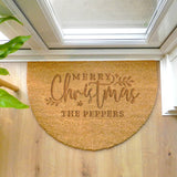 Personalized Christmas doormat with 'Merry Christmas THE PEPPERS' text on a wooden floor.