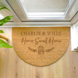 Doormat with 'Charlie & Wills Home Sweet Home' text on a wooden floor.