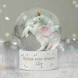 Unicorn figurine inside a snow globe with 'Follow your dreams Lily' text on a stand.