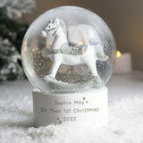 Personalized snow globe with rocking horse on a snowy base, featuring the text 'Sophia May On Your 1st Christmas 2022'.