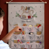 Advent calendar with a rocking horse design and numbered pockets, being interacted with by a child.