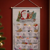 Advent calendar with Santa Claus and reindeer design on a red wall.