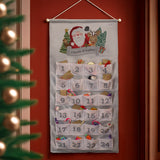 Felt Advent calendar with Santa Claus design on a red wall