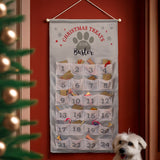 Dog treat advent calendar hanging on a wall with a dog in front