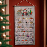 Christmas advent calendar with penguin design on a red wall