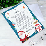 Letter from Santa Claus with festive design on a wooden surface