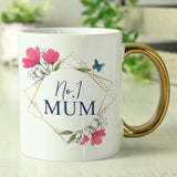 White mug with floral design and 'No. 1 Mum' text on a blurred background