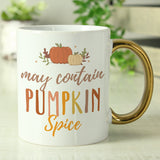 Personalised white mug with gold handle featuring the phrase "May contain pumpkin spice"