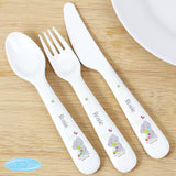 A set of white plastic cutlery featuring a 'Tiny Tatty Teddy Cuddle Bug' design, consisting of a spoon, knife, and fork.