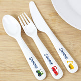 A set of personalized white plastic cutlery including a spoon, knife, and fork, each with a different colour vehicle graphic on the handle.