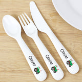 White cutlery set with 'Oliver' and tractor design on a wooden surface