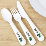 White cutlery set with 'Eddie' and a tractor design on a wooden surface