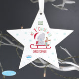 Personalised Wooden Heart Shaped Christmas Tree Decoration with the writing "My 1st Christmas" with image of Tiny Tatty Teddy Bear on Christmas sleigh hanging with white ribbon