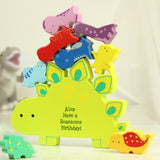 Colorful dinosaur-shaped toy with small dinosaur figures on a light background
