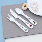 Personalized cutlery set with 'SOPHIA' on a grey placemat.
