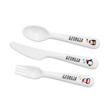 Set of white cutlery with 'Georgia' and a penguin design on a white background