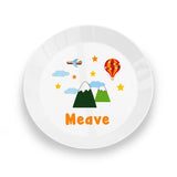 White plate with colourful mountain, airplane, and hot air balloon design on a white background