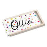 Rectangular tray with colorful polka dots and the name 'Ollie' on a white background