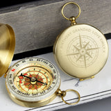 A gold-coloured personalised keepsake compass with a brushed metal effect, shown open with the inscription 'Happy Birthday Grandad, love Emily' on the cover, and a solid, unadorned face displaying a directional scale.