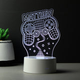 A personalised LED gaming night light in the shape of a game controller, with the name 'Matthew' written on it, illuminated in white.